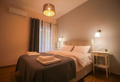 a bedroom with a bed with two towels on it at The Athenian Hive in Athens