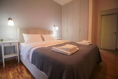 a bedroom with a bed with two towels on it at The Athenian Hive in Athens