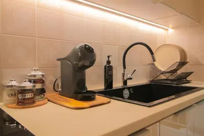 a kitchen counter with a sink and a mixer at The Athenian Hive in Athens