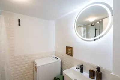 a bathroom with a sink and a mirror at 2BR Designer Apt Near Metro With Private Garden in Athens