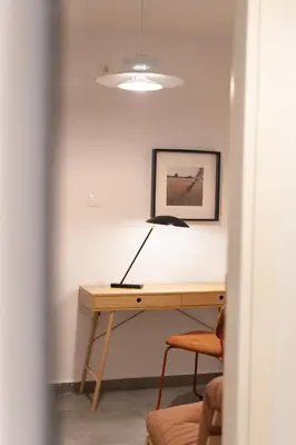 a desk with a lamp on it in a room at 2BR Designer Apt Near Metro With Private Garden in Athens