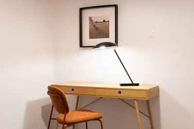 a desk with a lamp and a chair at 2BR Designer Apt Near Metro With Private Garden in Athens