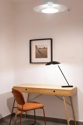 a desk with a lamp and a chair at 2BR Designer Apt Near Metro With Private Garden in Athens