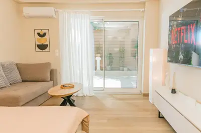 a living room with a couch and a table at Plantaea Deluxe Studio - Athens Modern Escape in Athens