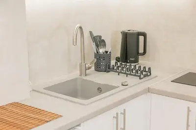a kitchen counter with a sink in a kitchen at Plantaea Deluxe Studio - Athens Modern Escape in Athens