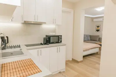 a kitchen with a sink and a microwave at Plantaea Deluxe Studio - Athens Modern Escape in Athens
