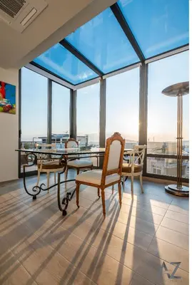 a dining room with a table and chairs and large windows at Art Acropolis Apartment Panos in Athens