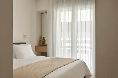 a bedroom with a bed and a large window at Athens Glow 2bd Apt in Ilisia in Athens