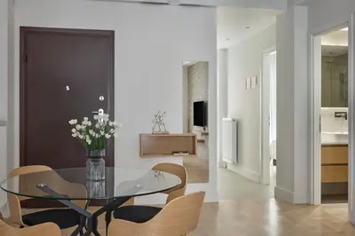 a dining room with a glass table and chairs at Athens Glow 2bd Apt in Ilisia in Athens