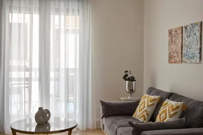 a living room with a couch and a table at Athens Glow 2bd Apt in Ilisia in Athens