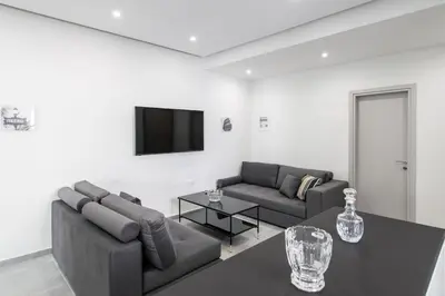a living room with two couches and a table at Εξαιρετικό διαμέρισμα στη Γλυφάδα in Athens