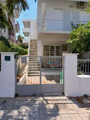 a white gate in front of a house at Εξαιρετικό διαμέρισμα στη Γλυφάδα in Athens