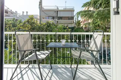 a table and two chairs on a balcony at Εξαιρετικό διαμέρισμα στη Γλυφάδα in Athens