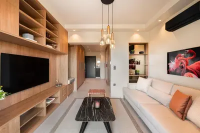 a living room with a couch and a tv at Voula Urban Escape in Athens
