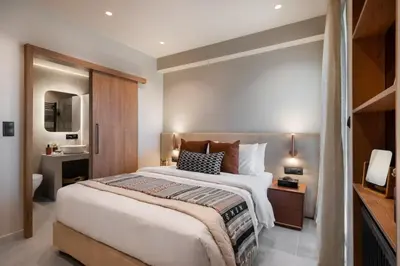 a bedroom with a large bed and a bathroom at Voula Urban Escape in Athens