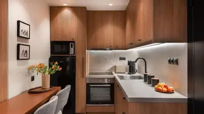 a kitchen with a sink and a counter with a table at Voula Urban Escape in Athens