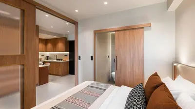 a bedroom with a large bed and a bathroom at Voula Urban Escape in Athens