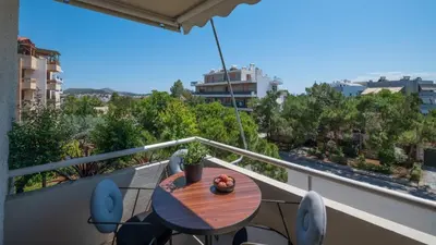a balcony with a table and chairs on a balcony at Voula Urban Escape in Athens