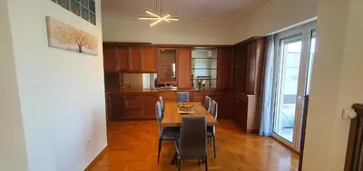 a kitchen with a table and chairs and a dining room at Marina Zeas Apartment for Big Group in Piraeus