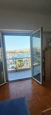 a room with a large sliding glass door with a view at Marina Zeas Apartment for Big Group in Piraeus