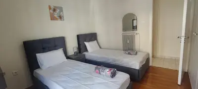 a room with two beds and a mirror at Marina Zeas Apartment for Big Group in Piraeus
