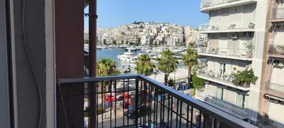 a balcony of a building with a view of a harbor at Marina Zeas Apartment for Big Group in Piraeus
