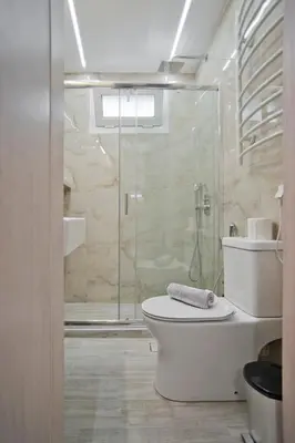 a bathroom with a toilet and a glass shower at The Little House at Moschato 1BR, WiFi, AC in Piraeus