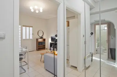 a living room with a glass door leading to a kitchen at The Little House at Moschato 1BR, WiFi, AC in Piraeus