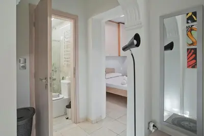 a white bathroom with a black lamp in a room at The Little House at Moschato 1BR, WiFi, AC in Piraeus