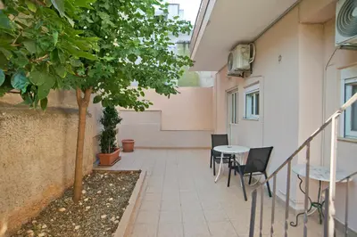 a courtyard with a table and chairs in a building at The Little House at Moschato 1BR, WiFi, AC in Piraeus