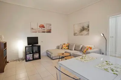 a living room with a couch and a tv at The Little House at Moschato 1BR, WiFi, AC in Piraeus