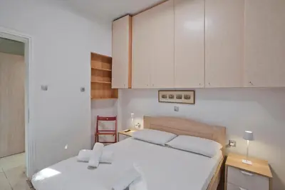 a bedroom with a white bed and white cabinets at The Little House at Moschato 1BR, WiFi, AC in Piraeus