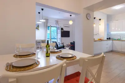a dining room and kitchen with a table and chairs at Elegant 3BDR Apt in Koukaki Near Acropolis in Athens