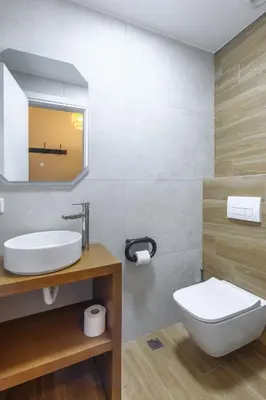 a bathroom with a white toilet and a sink at Elegant 3BDR Apt in Koukaki Near Acropolis in Athens