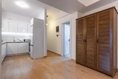 a kitchen with a large wooden closet in a room at Elegant 3BDR Apt in Koukaki Near Acropolis in Athens