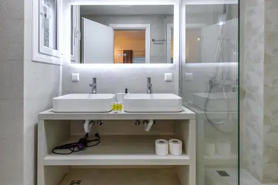 a bathroom with two sinks and a shower at Elegant 3BDR Apt in Koukaki Near Acropolis in Athens