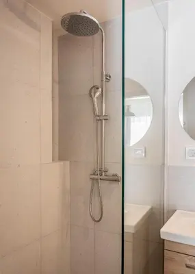 a shower with a shower head in a bathroom at Link by Zoia Living in Athens