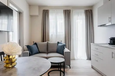 a living room with a couch and a table at Link by Zoia Living in Athens