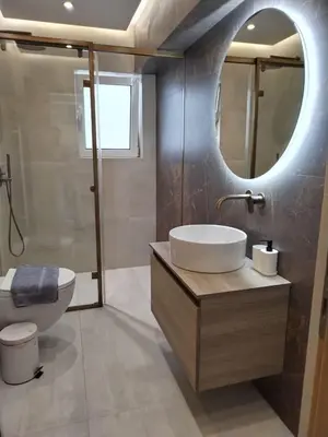 a bathroom with a sink and a toilet and a mirror at Amazing Sea View Next To The Beach 2bd Apt in Athens