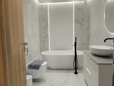 a bathroom with a tub and a toilet and a sink at Amazing Sea View Next To The Beach 2bd Apt in Athens
