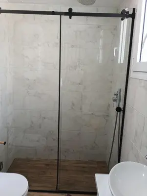 a shower with a glass door in a bathroom at Βιργινία κοντα σε μετρο πανορμου και σε νοσοκομεια in Athens