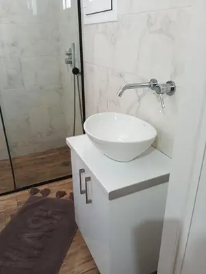 a bathroom with a white sink and a shower at Βιργινία κοντα σε μετρο πανορμου και σε νοσοκομεια in Athens