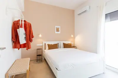 a bedroom with a white bed and a window at Livinn Acropolis View LV in Athens