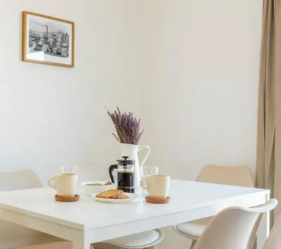 a white table with two cups of coffee and pastries at Livinn Acropolis View LV in Athens