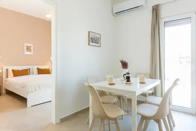 a white dining room with a white table and chairs at Livinn Acropolis View LV in Athens