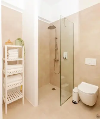 a bathroom with a shower stall and a toilet at Livinn Acropolis View LV in Athens