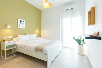 a bedroom with a white bed and a window at Livinn Acropolis View LV in Athens