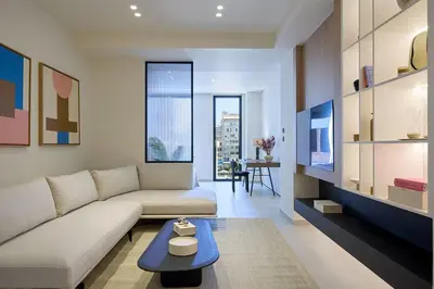 a living room with a couch and a table at Fasma Suites Luxury Apartments in Piraeus in Piraeus
