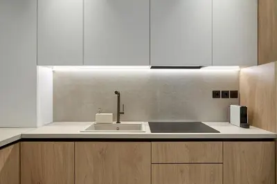 a kitchen with a sink and white cabinets at Fasma Suites Luxury Apartments in Piraeus in Piraeus