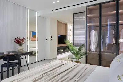 a bedroom with a bed and a desk and a dressing room at Fasma Suites Luxury Apartments in Piraeus in Piraeus